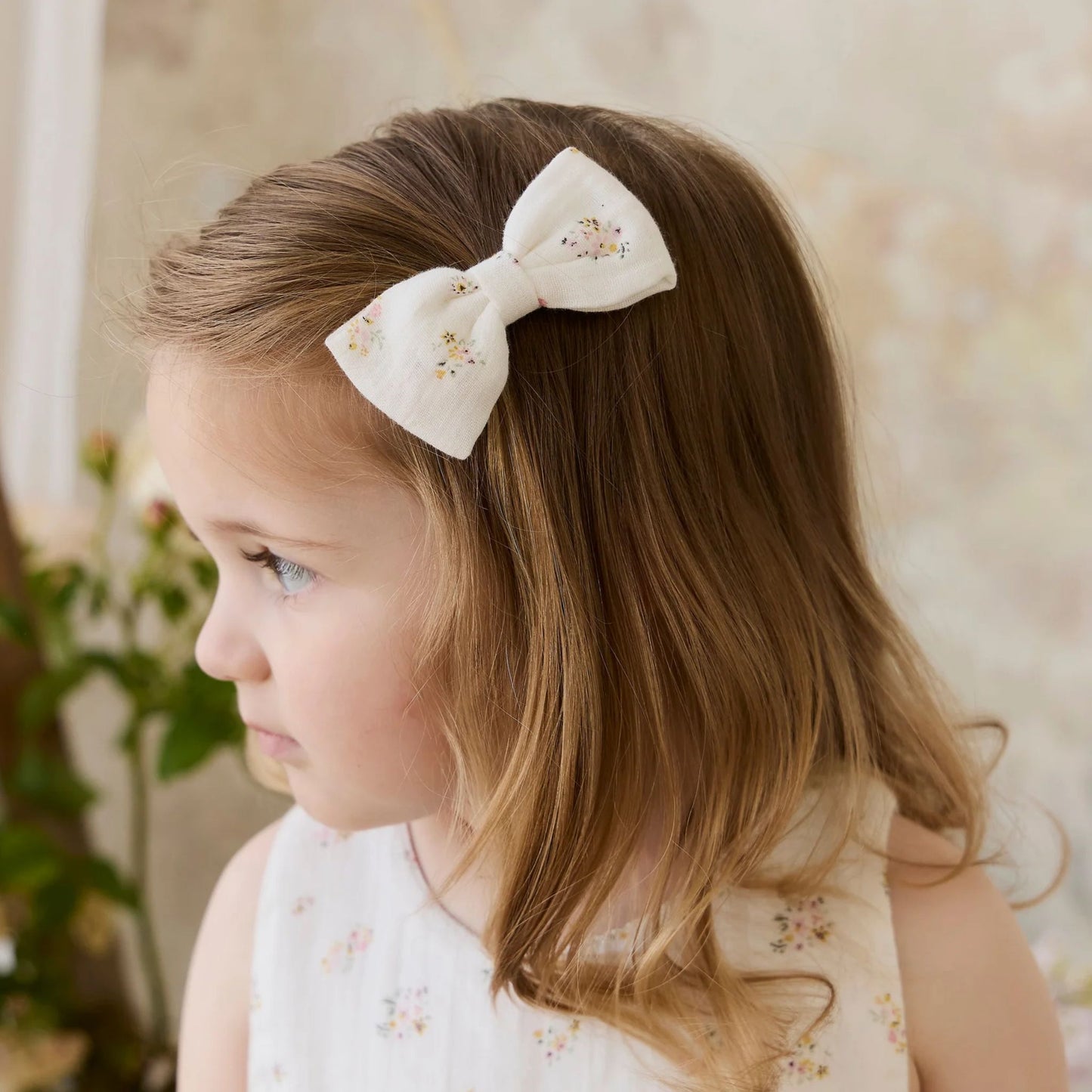 Child wearing Jamie Kay Organic Cotton Désirée Bow in Ayla Whisper