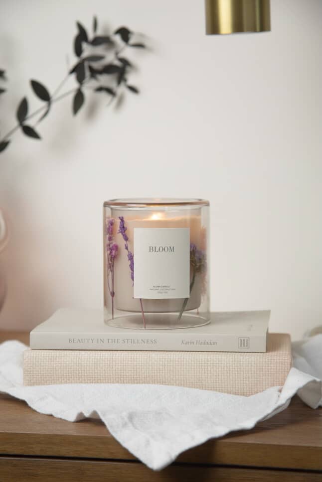 Elegant candle decorated with dried florals from the Grace & Haven candle making class in Essex CT.