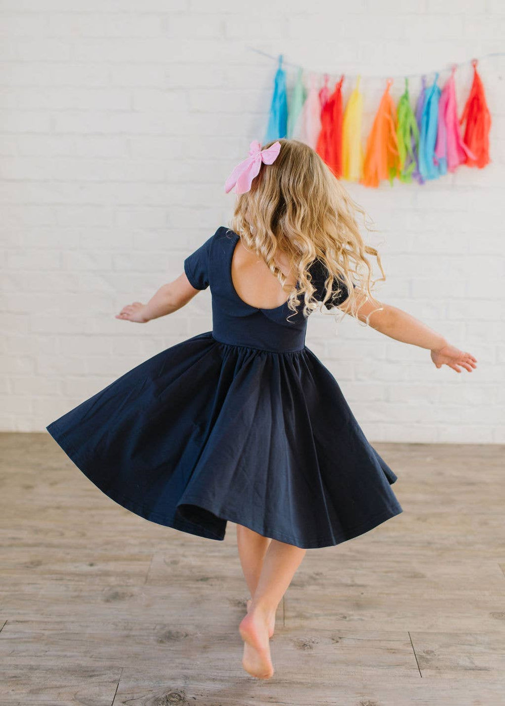 Close-up of Elizabeth navy dress for toddlers showing scoop back with wrap-around collar detail.