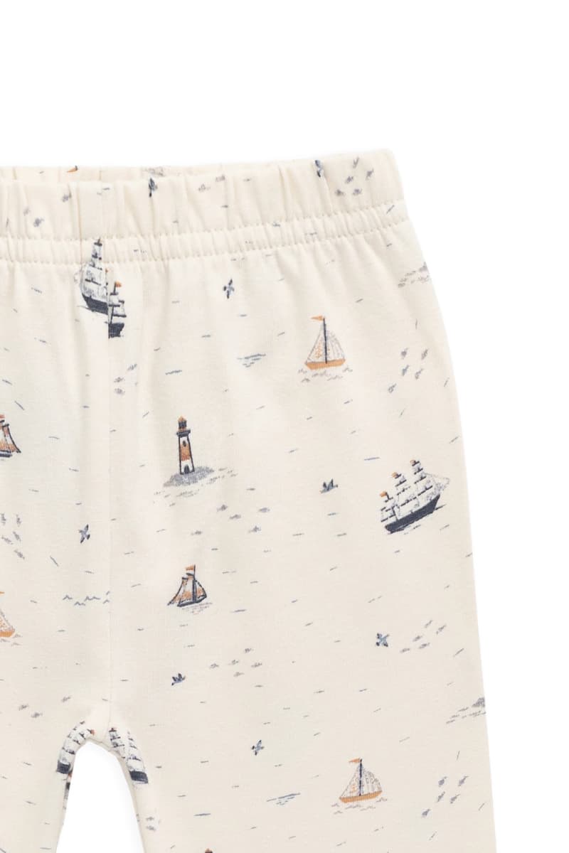 Close-up of Sailing Day sailboat and lighthouse print on Jamie Kay leggings