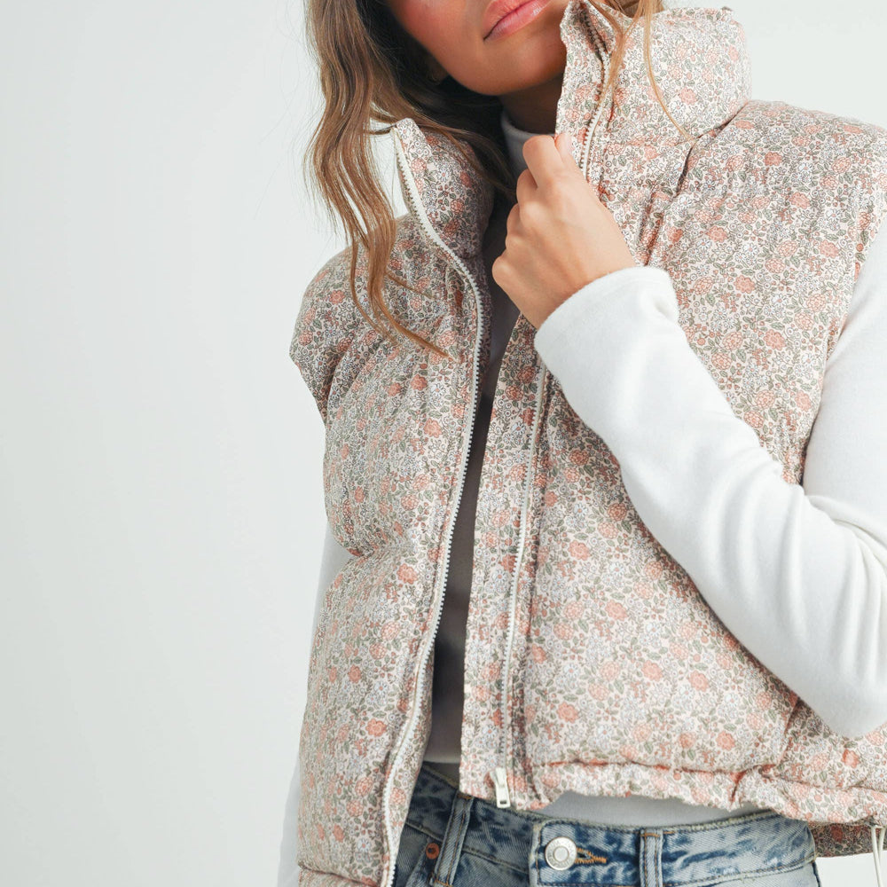 
                      
                        Close-up of model wearing the Floral High Neck Puffer Vest, focusing on high collar, shoulder structure, and subtle floral print
                      
                    