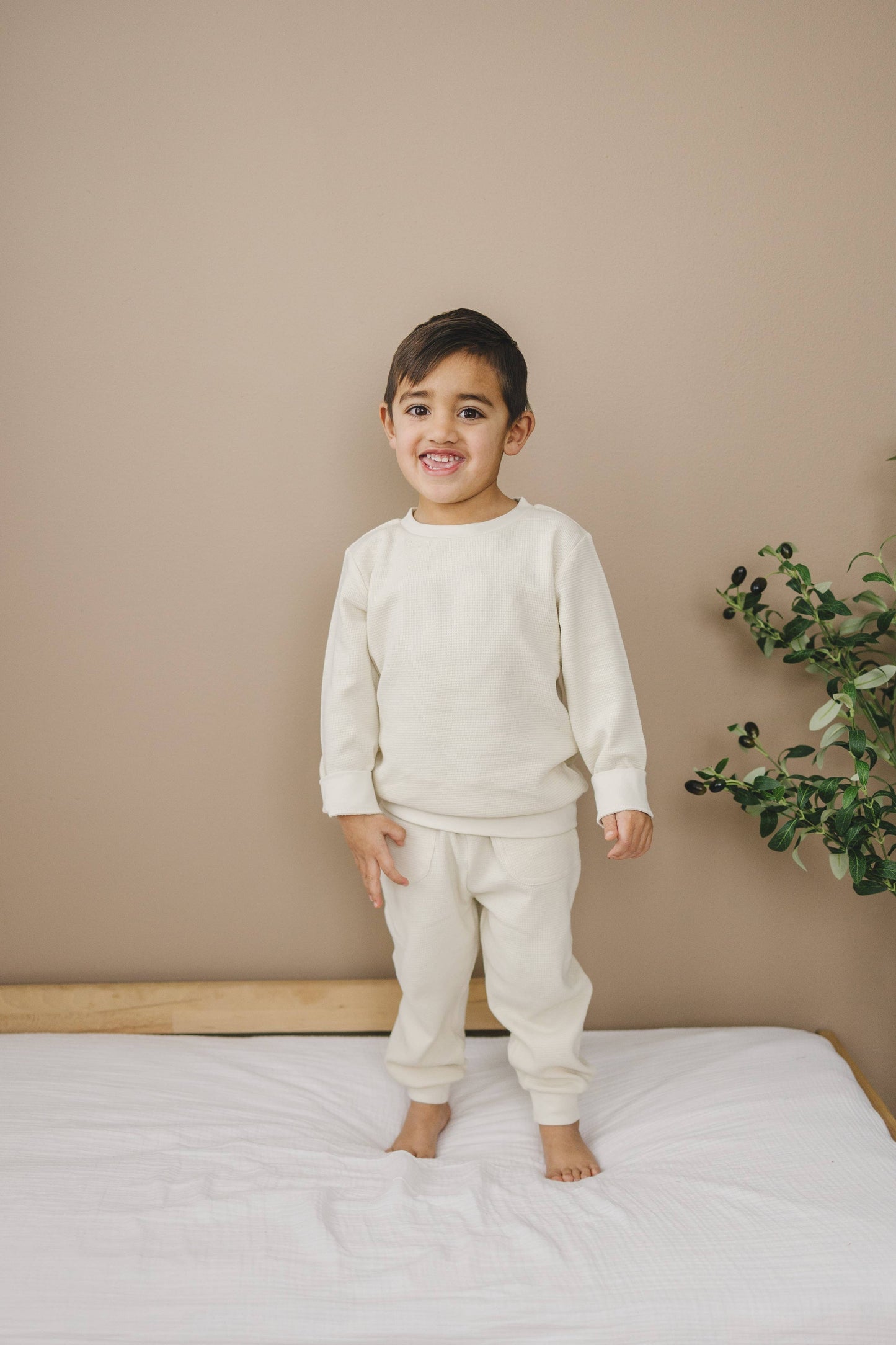 Child wearing organic waffle knit jogger pants during play