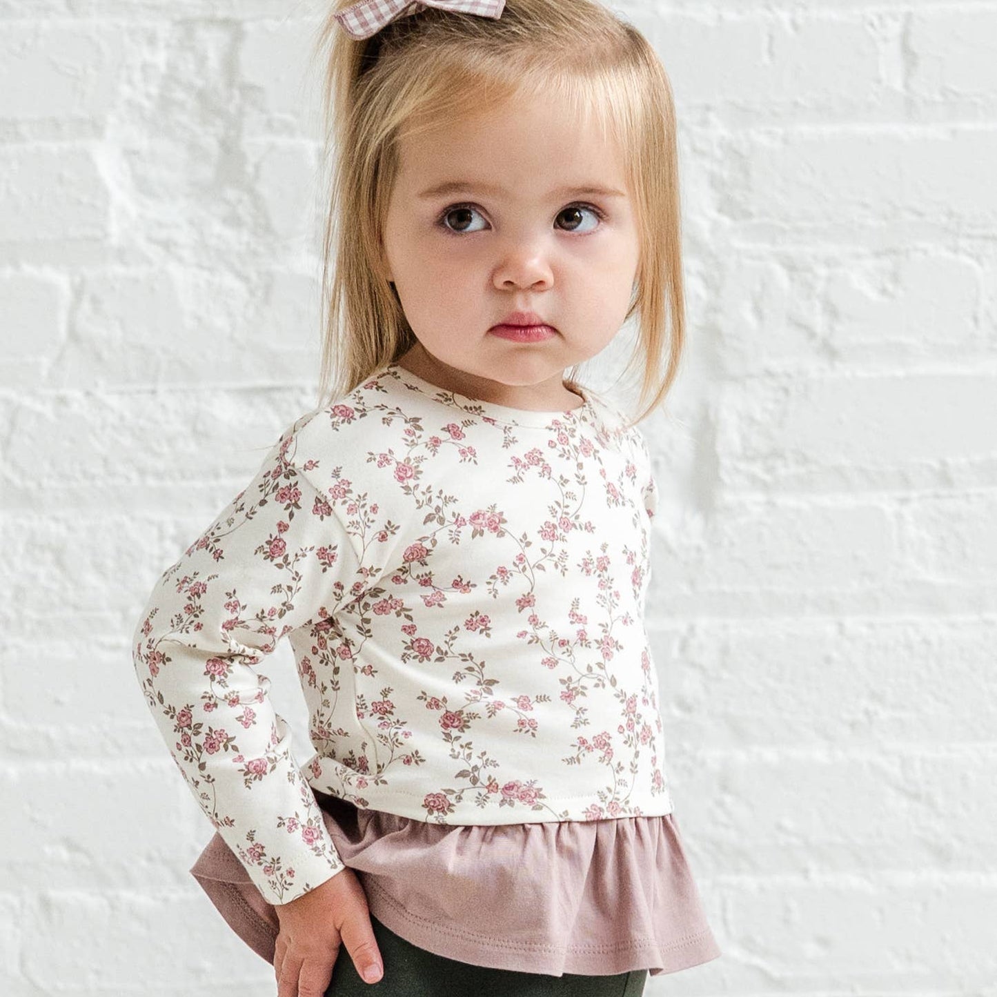 Child wearing Lily long sleeve ruffle hem top by Colored Organics