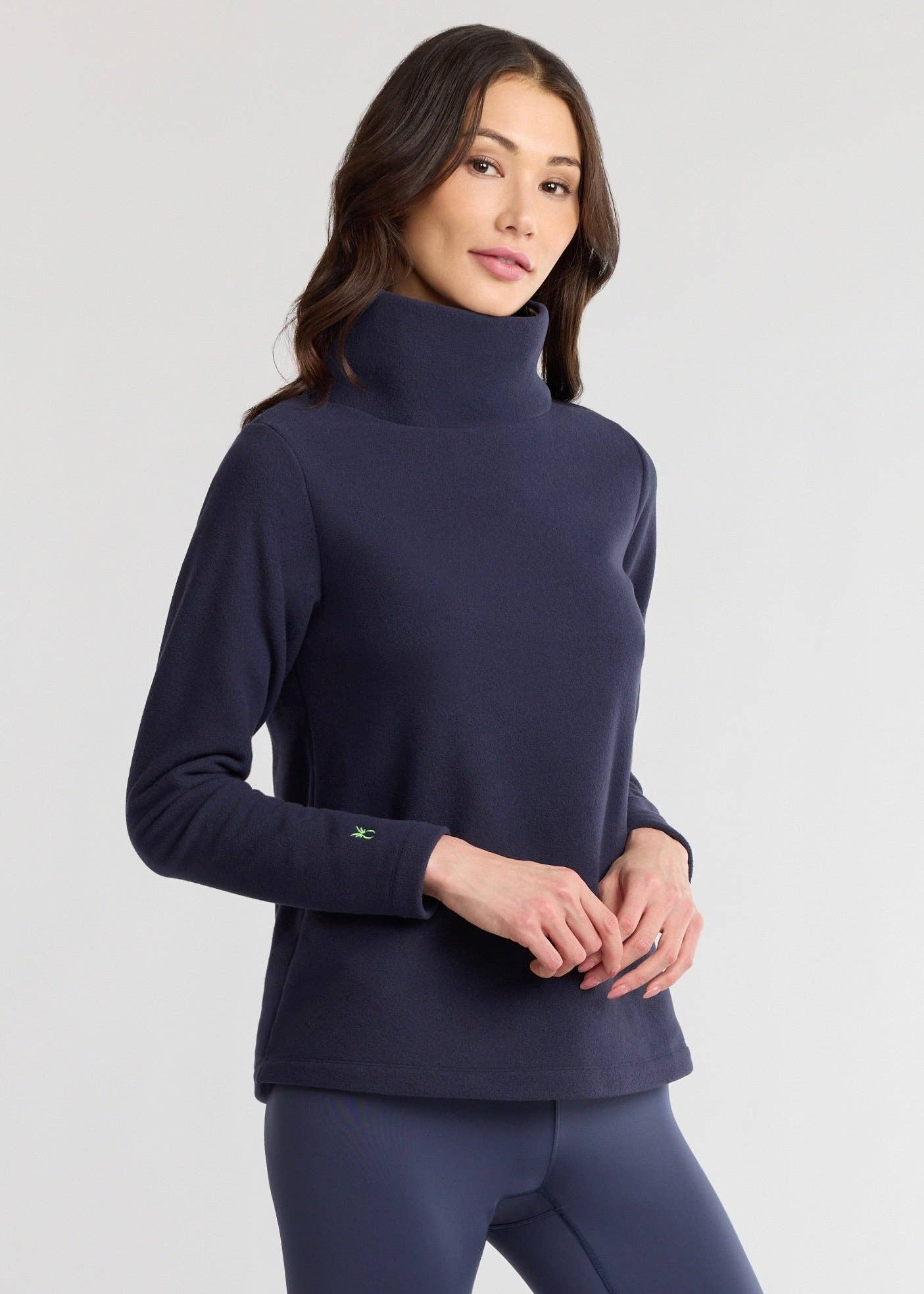 Model wearing Greenpoint Vello Fleece Turtleneck in navy with relaxed fit and long sleeves