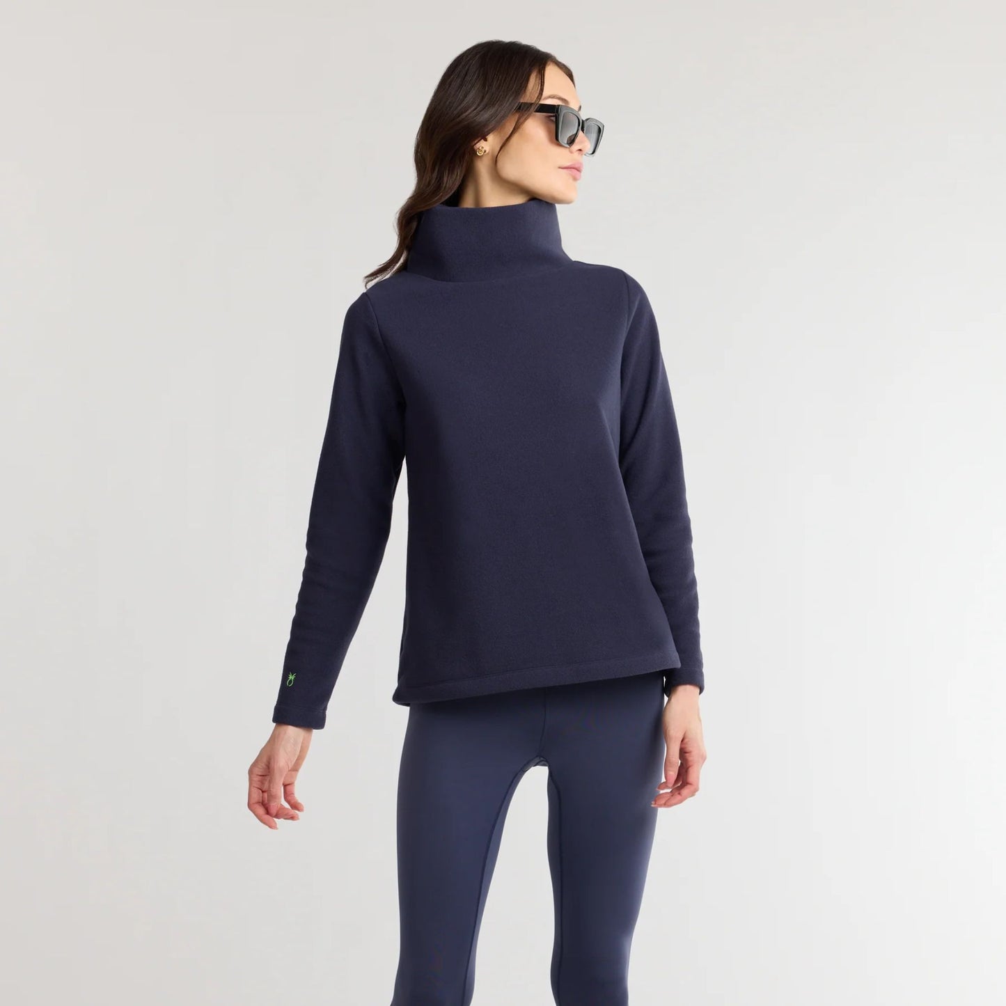 Model wearing Greenpoint Vello Fleece Turtleneck in navy with relaxed fit and long sleeves
