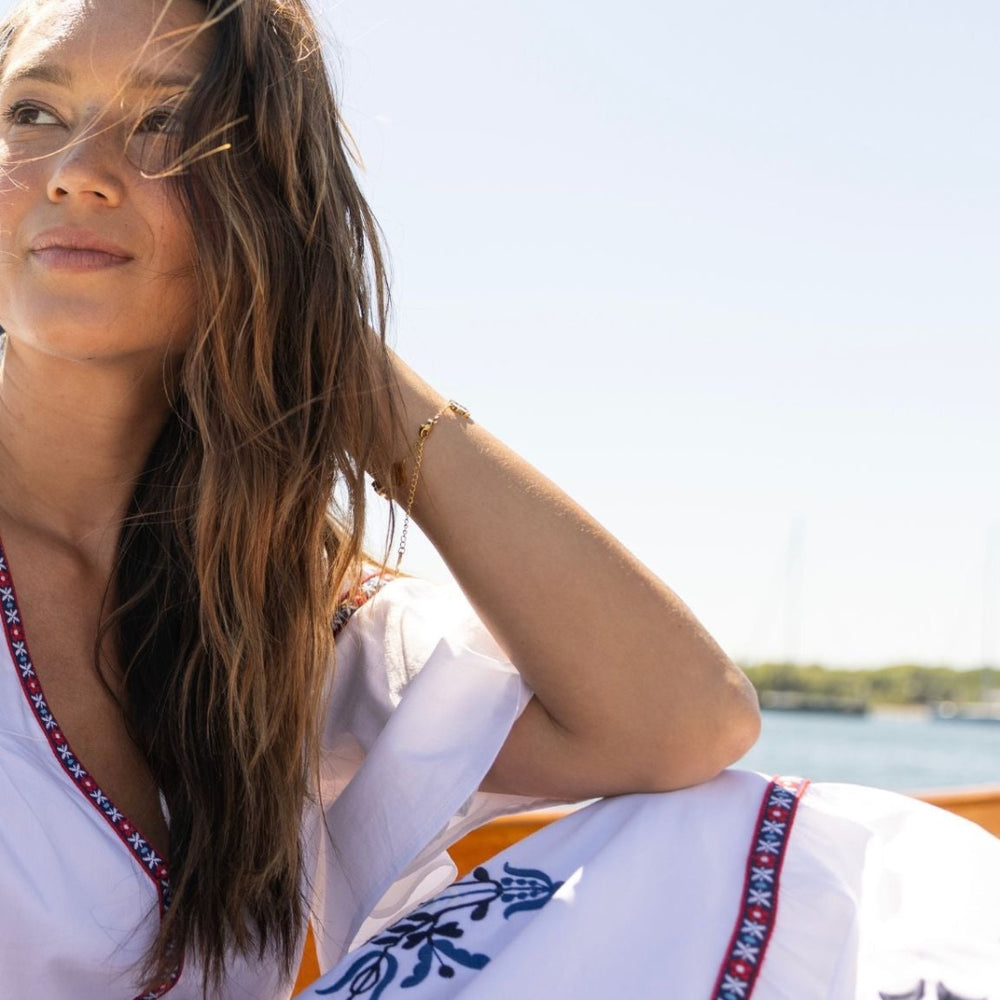
                      
                        Woman in the Harbor Dress gazing out over the water from a boat, summer fashion
                      
                    
