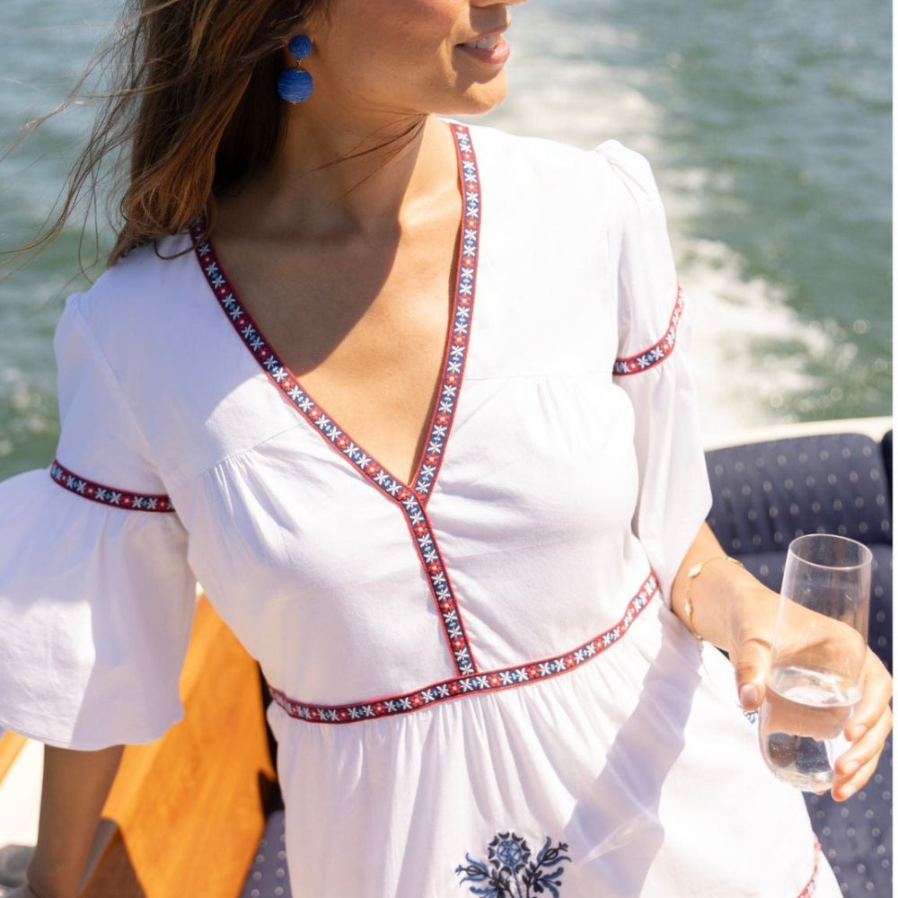 Woman wearing the Ivy Coast Harbor Dress on a boat, enjoying a sunny summer day