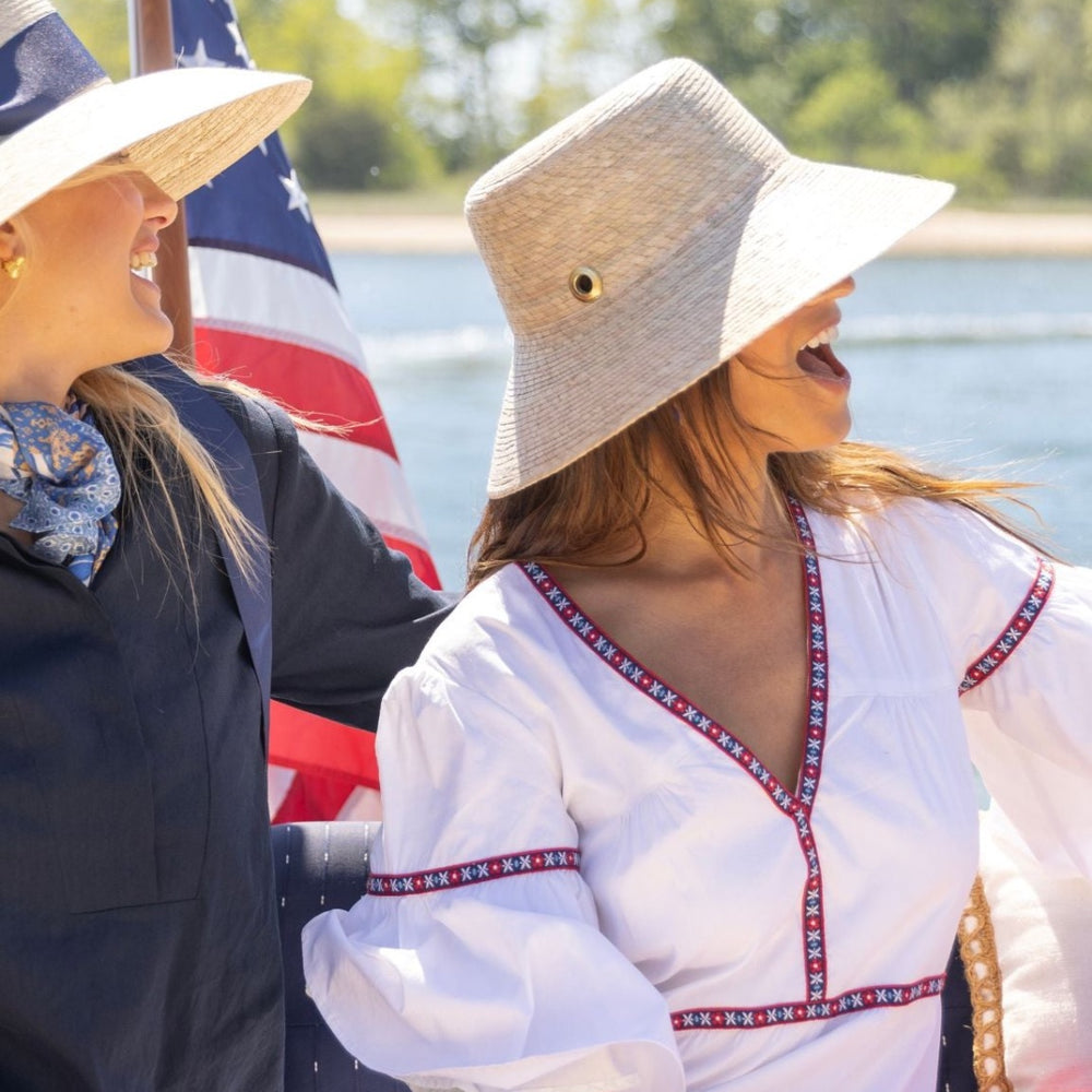 
                      
                        Women wearing the Ivy Coast Harbor Dress together on a boat, enjoying a coastal summer day
                      
                    