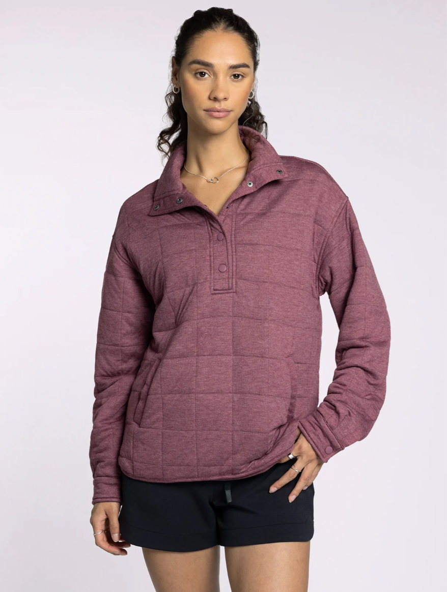 Close-up of the Indiana Pullover in rose, featuring soft quilted fabric and zip collar detail.