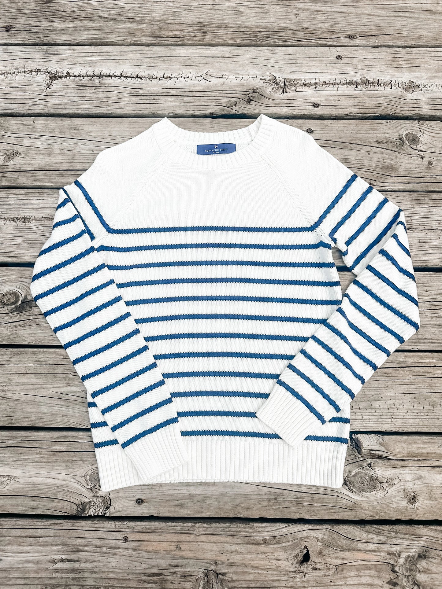 Front view of the Ivory & Navy Striped Sweater with classic nautical pattern and ribbed trim.