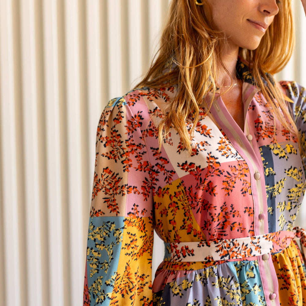 
                      
                        Detailed view of The Jules Dress top, highlighting the button-up placket, collar, and floral patchwork fabric.
                      
                    