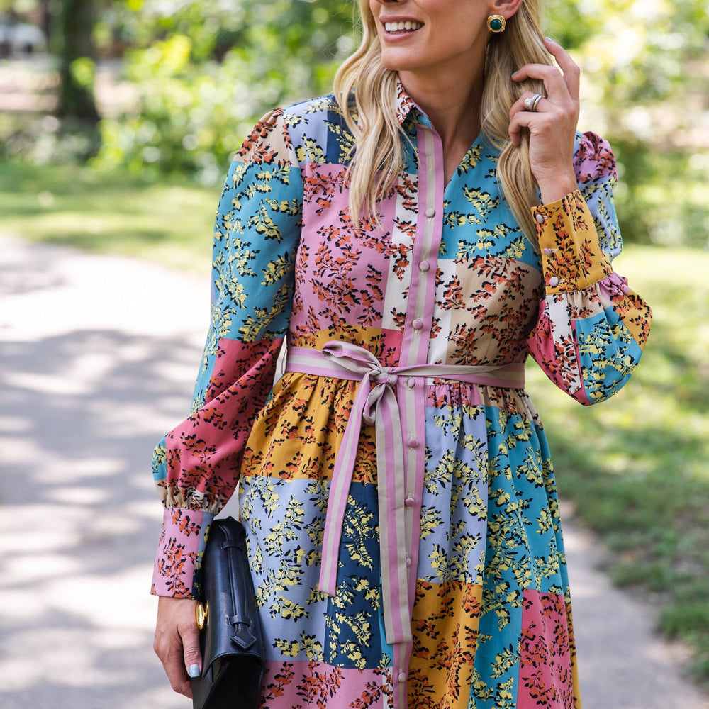 Close-up of The Jules Dress showing the bold cuff detail and colorful patchwork floral fabric.