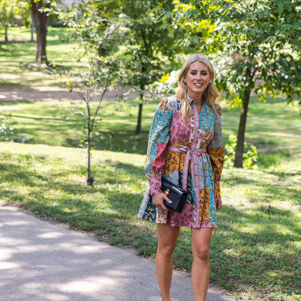 
                      
                        The Jules Dress styled in a lush garden, highlighting its bold patchwork floral print and effortless fit.
                      
                    