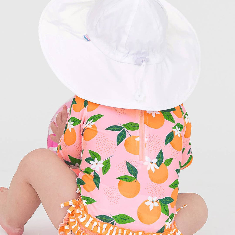 
                      
                        Back view of girl wearing white sun hat with swimsuit, highlighting neck coverage and tie under chin
                      
                    