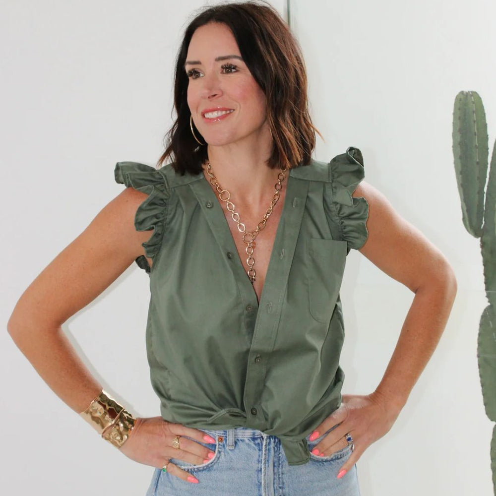 
                      
                        Waist-up studio image of designer Kate in the KMJ Olivia top in Olive, styled with jeans and showcasing the ruffle collar.
                      
                    