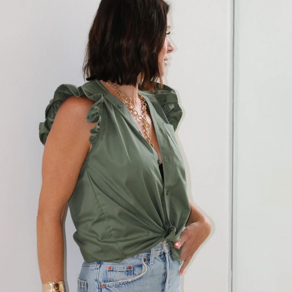 
                      
                        Side profile of designer Kate wearing the Olivia in Olive by KMJ, paired with denim in a studio setting.
                      
                    