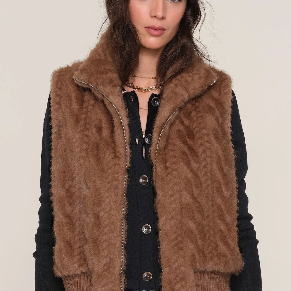Close-up of The Liana Vest layered over jeans on model, highlighting cozy texture and versatile styling.