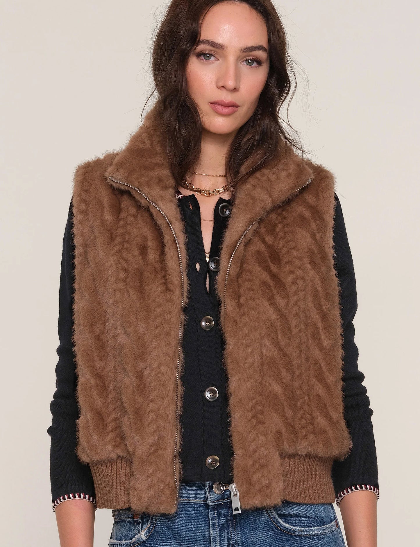 Close-up of The Liana Vest layered over jeans on model, highlighting cozy texture and versatile styling.