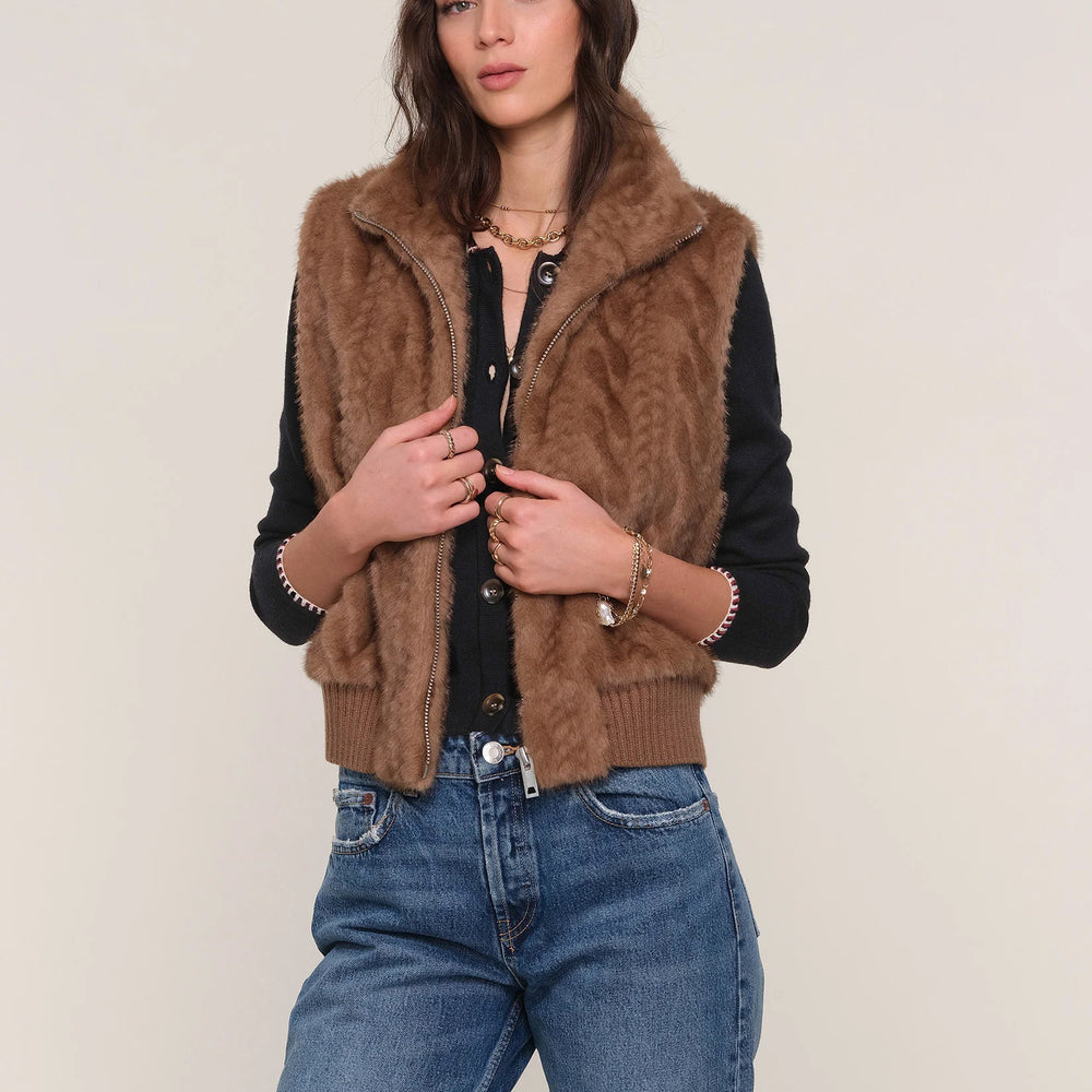 
                      
                        Model wearing The Liana Vest with denim, highlighting casual chic style and plush texture.
                      
                    