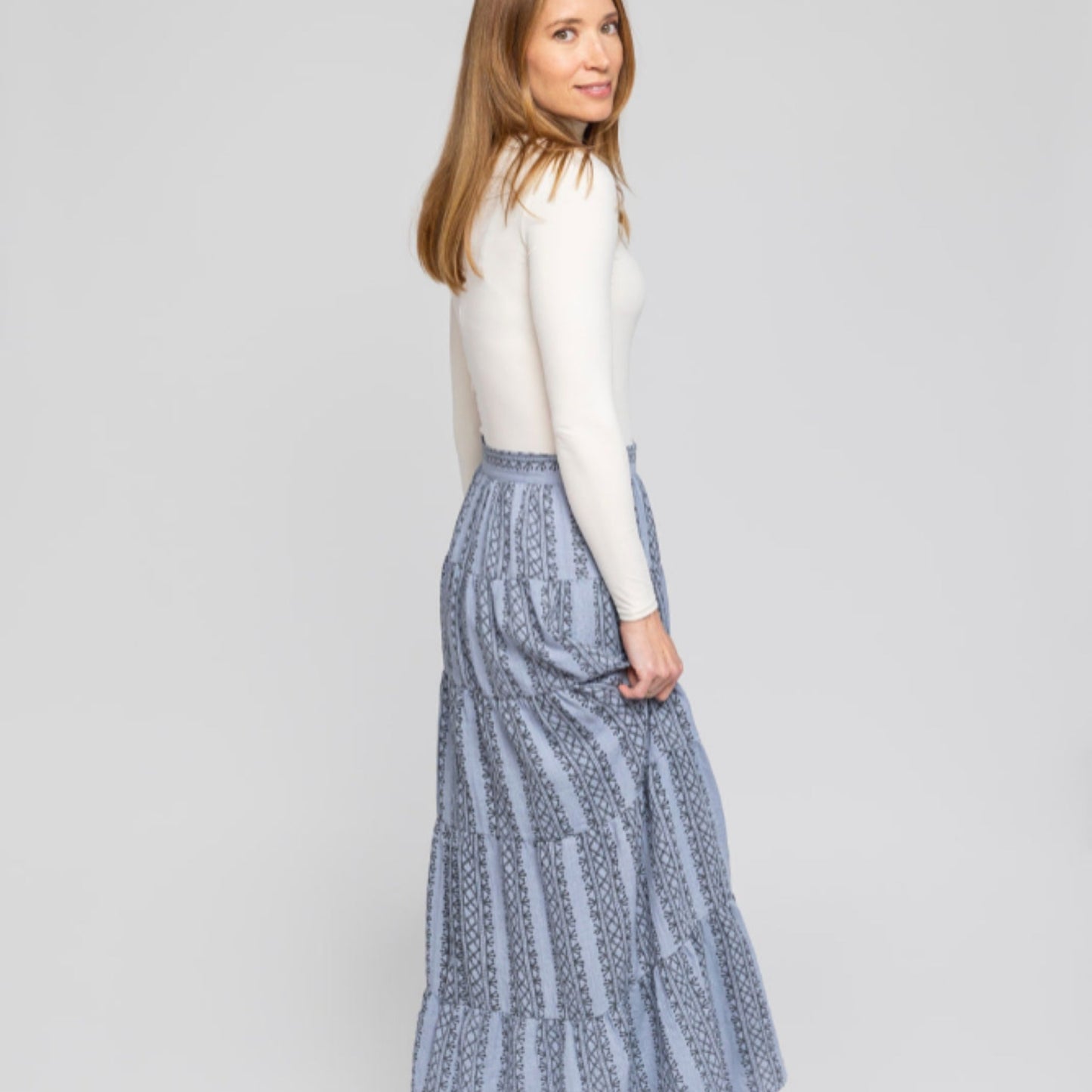 Back-angle lifestyle shot showing skirt flow and hidden pockets