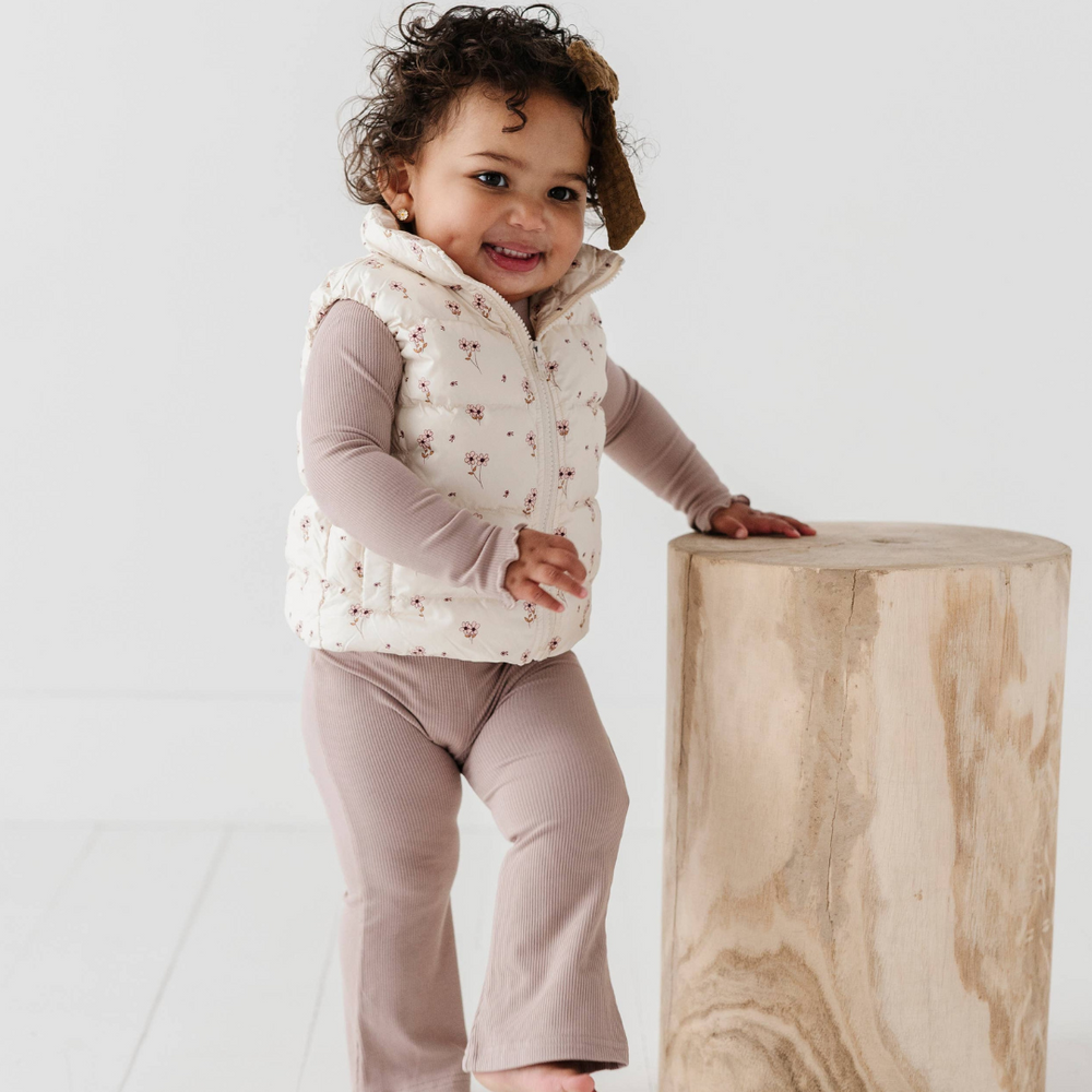 Toddler in stretchy ribbed bamboo flare pants, showing stylish flare design. Ideal for playtime and outings, paired with outerwear for fall.