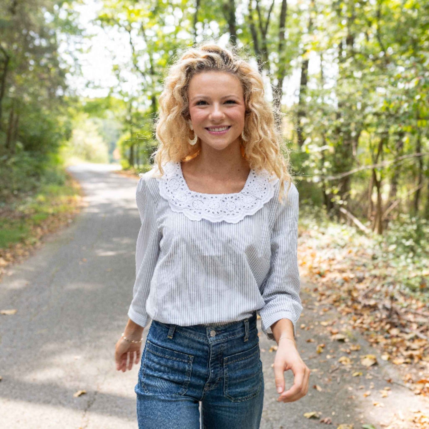 Lifestyle shot of Louise Top paired with high-waisted jeans
