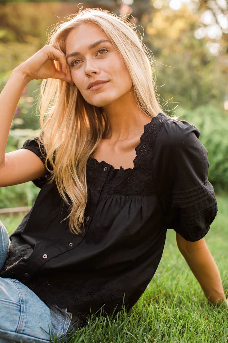 Square neckline and puff sleeve detail on the black Marea Liza top.
