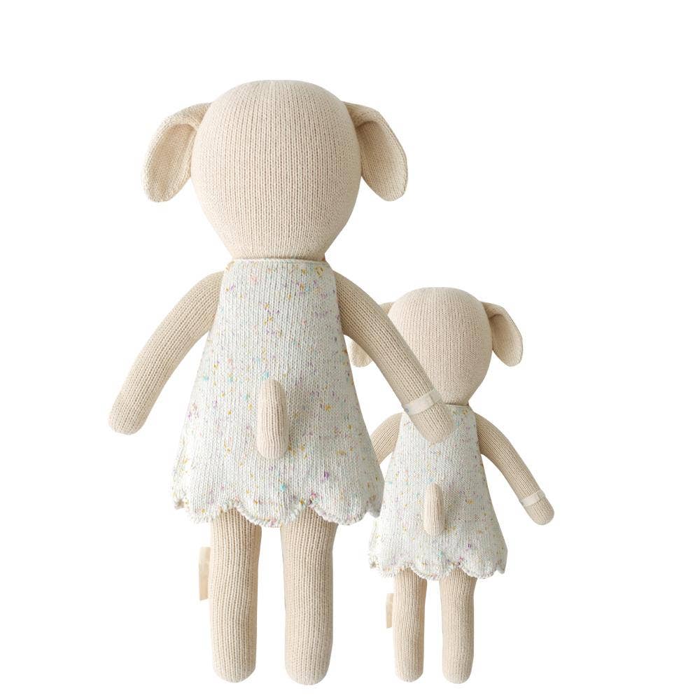 Back view flatlay of Mia the Dog dolls in both sizes showing hand-knit detail and tail