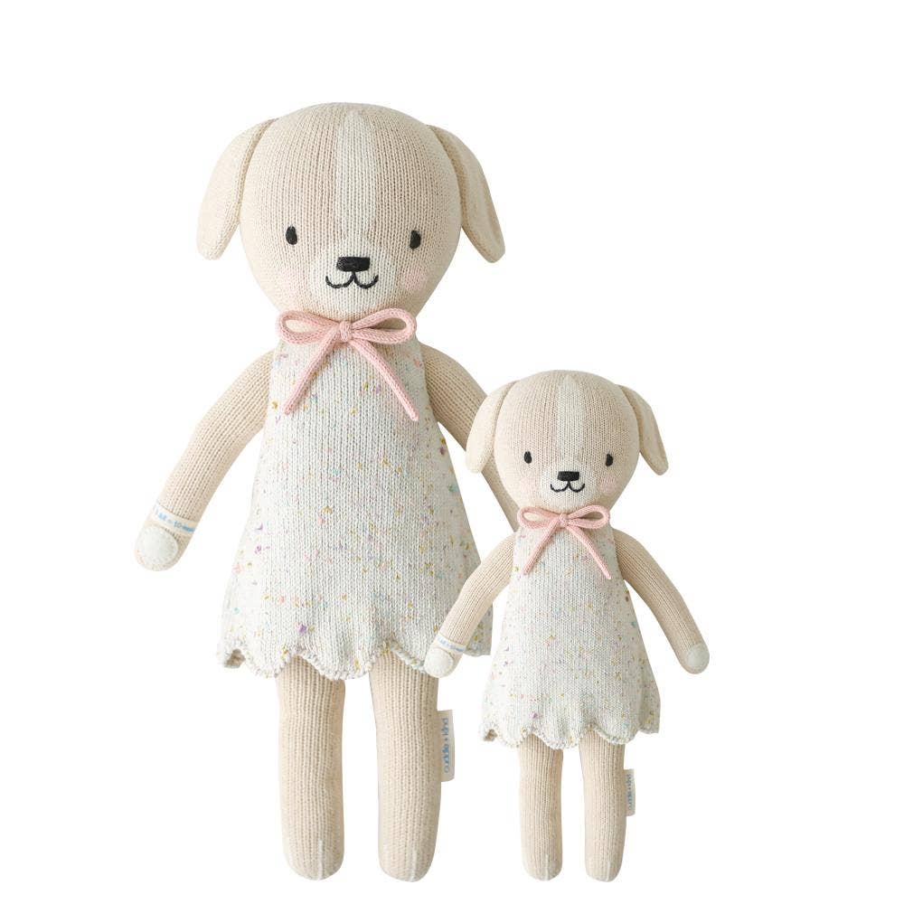 Flatlay of Mia the Dog cuddle+kind dolls in regular 20" and little 13" sizes side by side showing front view