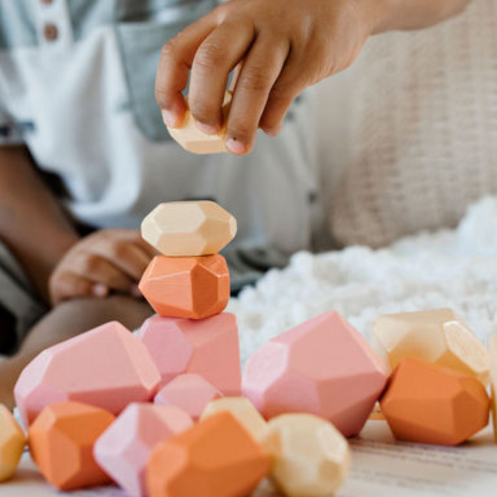 
                      
                        A collection of eco-friendly wooden Patience Pebbles in various colors, promoting mindfulness and creative play for kids.
                      
                    