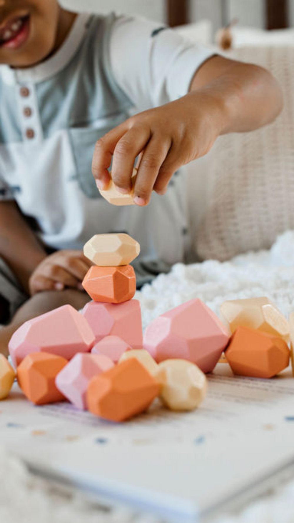 A collection of eco-friendly wooden Patience Pebbles in various colors, promoting mindfulness and creative play for kids.