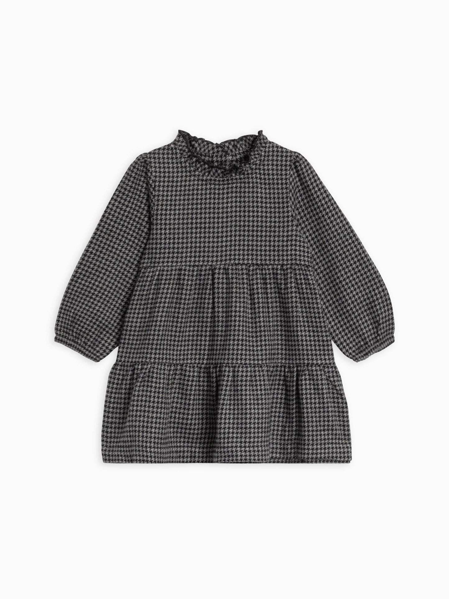 Flatlay of Neela Flannel Dress by Colored Organics in organic cotton, displaying ruffle neckline, long sleeves, and tiered skirt