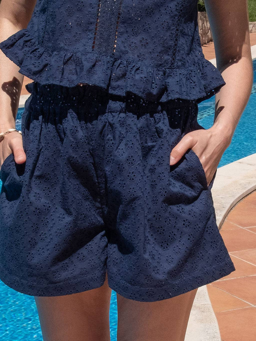 Close-up detail of Olivia organic cotton eyelet shorts in navy, showcasing texture, waistband, and stitching.