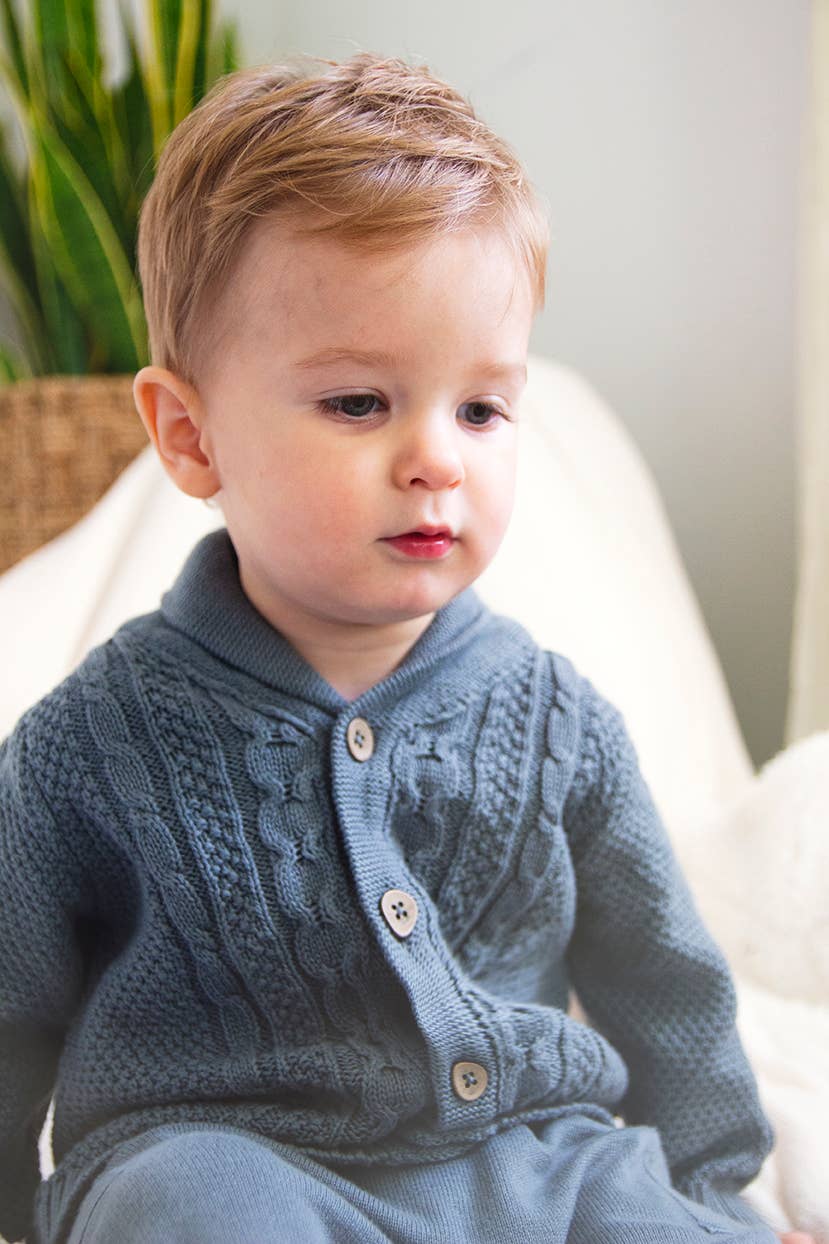 Seated baby boy in Viverano Organic Cable Knit Cardigan showing relaxed fit and soft organic cotton texture