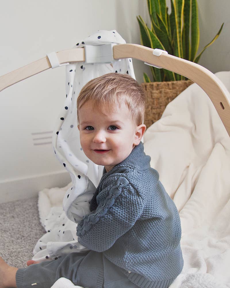 
                      
                        Baby boy in Viverano Organic Cotton Shawl Collar Cardigan turned slightly, showing side and back view
                      
                    