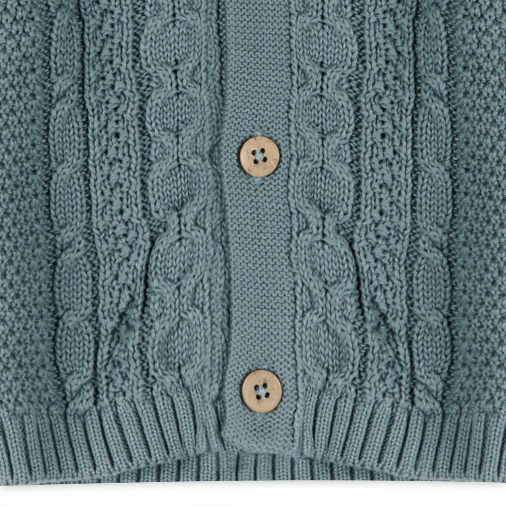 
                      
                        Close-up of front buttons and lower hem of Viverano Organic Cotton Cable Knit Baby Cardigan Sweater
                      
                    
