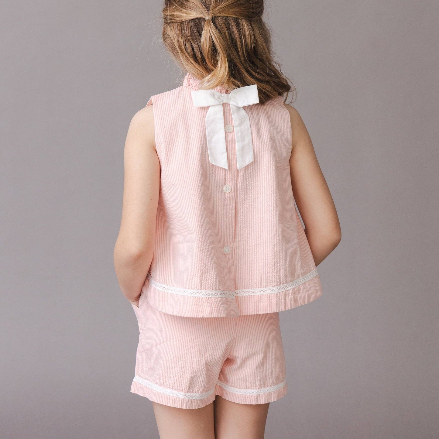 Girl wearing Organic Seersucker Pull-On Short in Rose — Grace & Haven, Essex CT