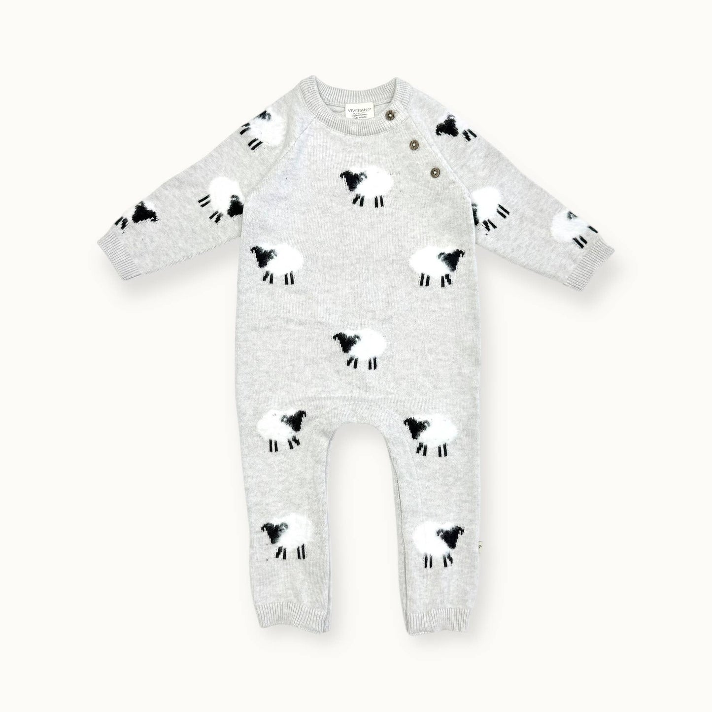 Flatlay of Viverano Organic Cotton Sheep Baby Jumpsuit in soft sweater knit with jacquard and appliqué details