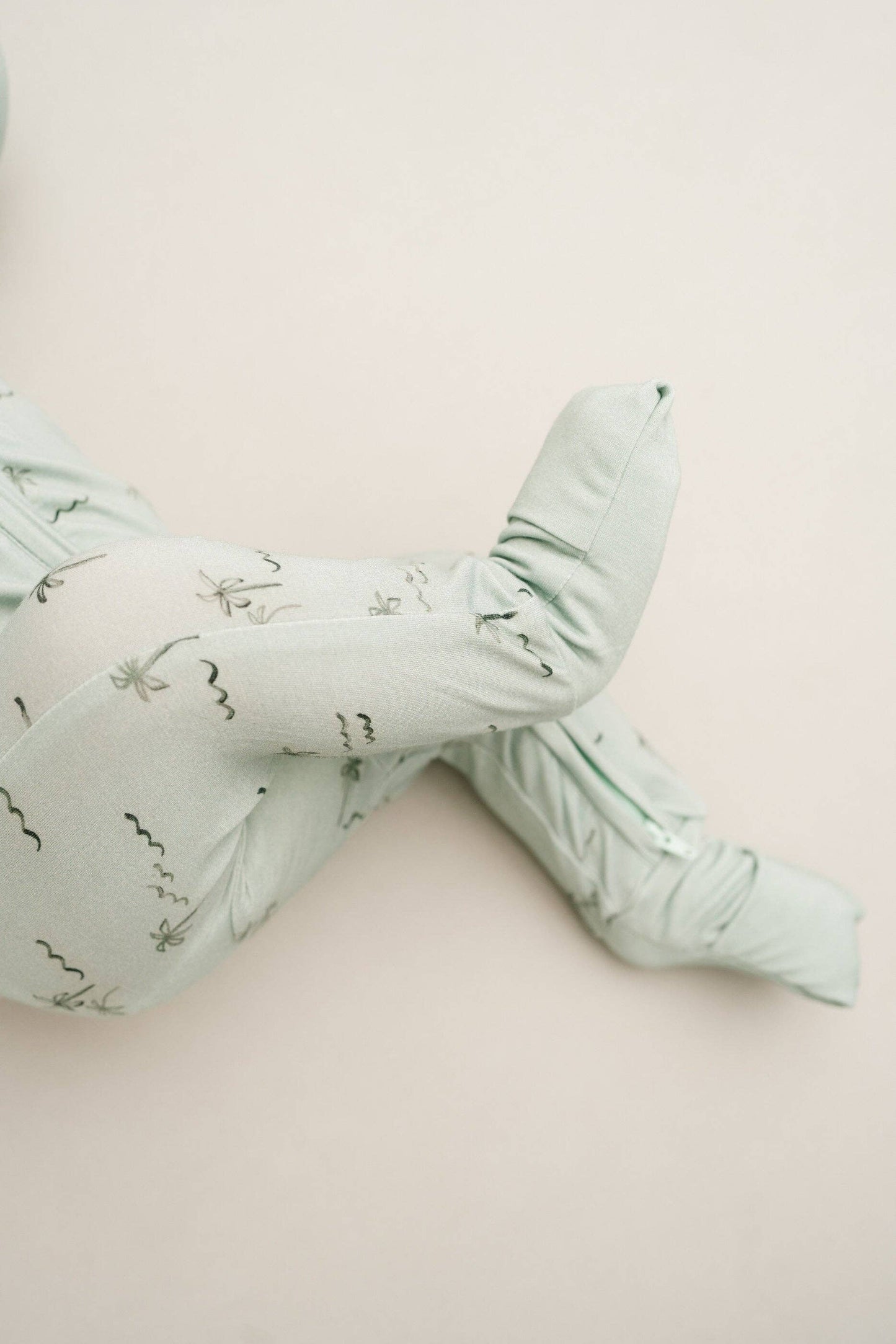 Close-up of Palm Breeze Bamboo Sleeper showing soft bamboo fabric and tropical palm print details.