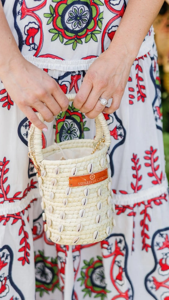 Front view of the Palm Shell Bucket Tote Citron showcasing its handwoven palm leaf design and golden strap.