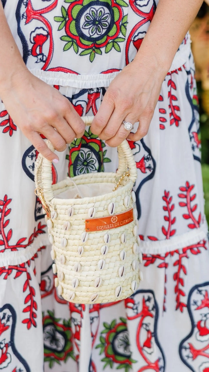 Front view of the Palm Shell Bucket Tote Citron showcasing its handwoven palm leaf design and golden strap.