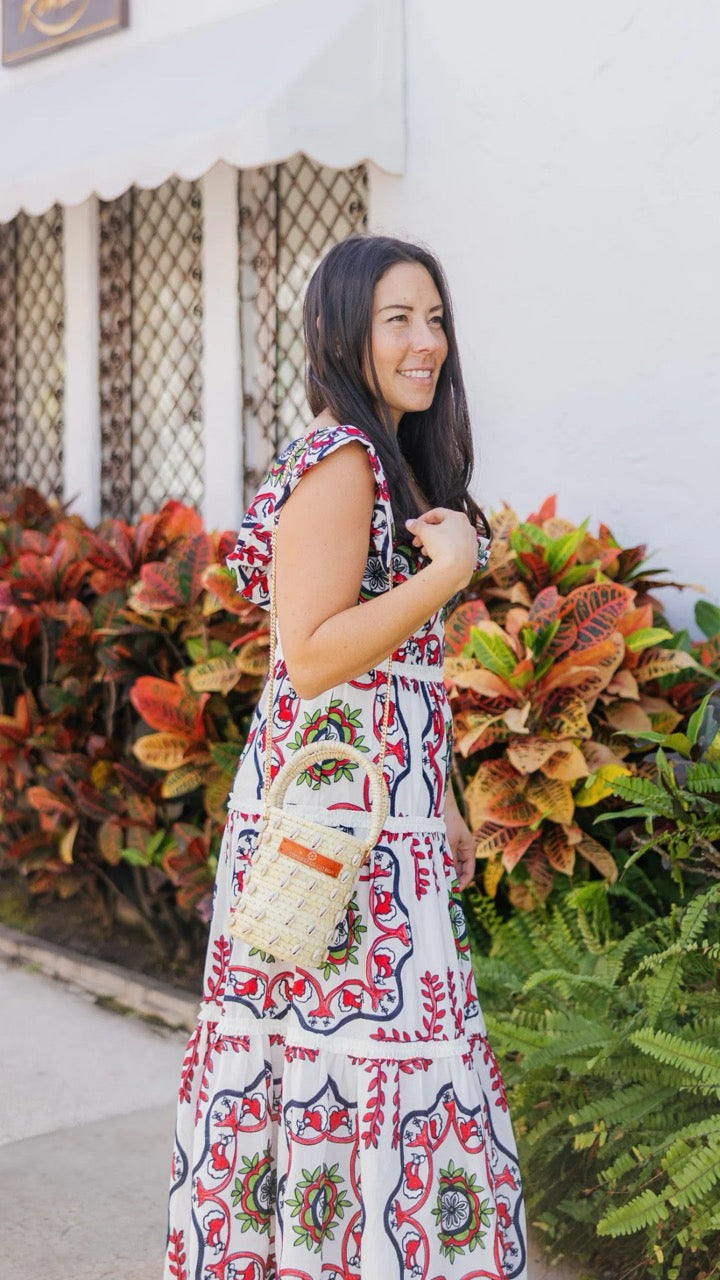 Lifestyle image of the Palm Shell Bucket Tote Citron being carried, highlighting its size and artisanal details.​