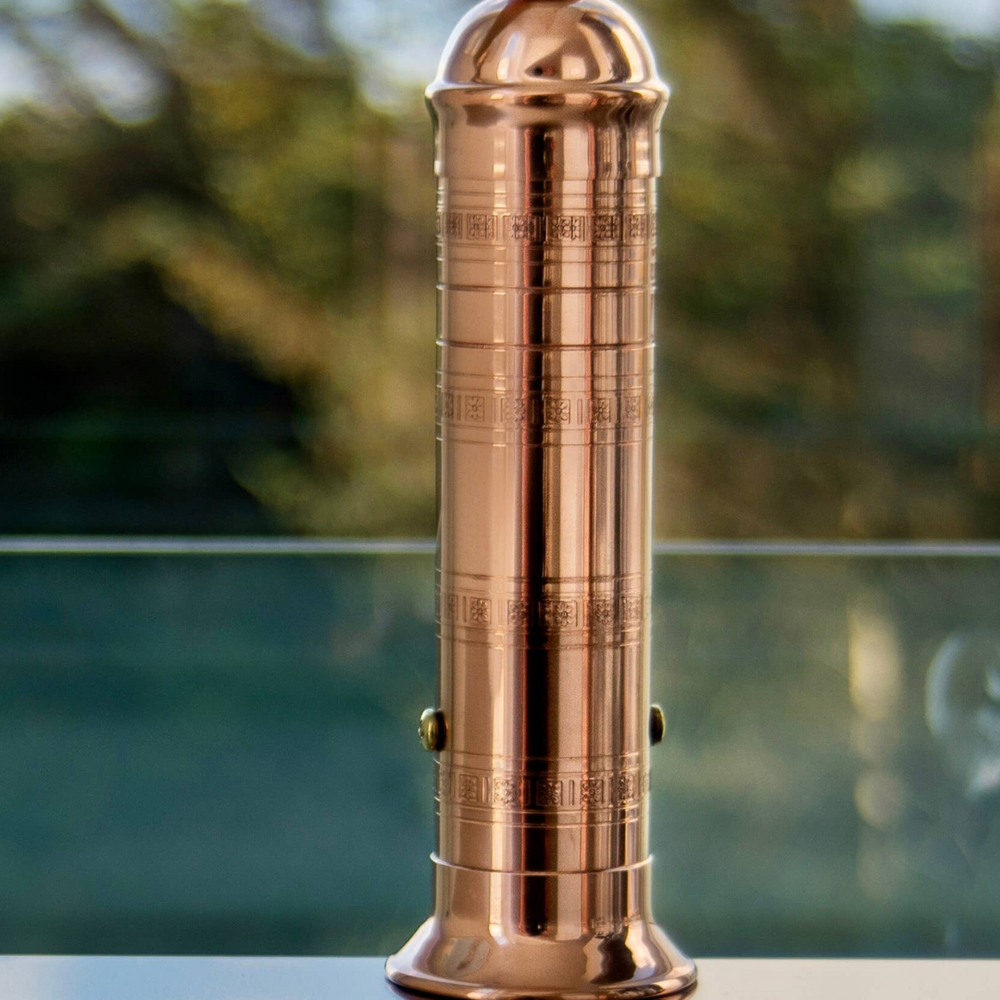 A solid copper 9-inch pepper mill from Alexander Handmade Mills, featuring a classic design with a powerful crank for optimal spice grinding.