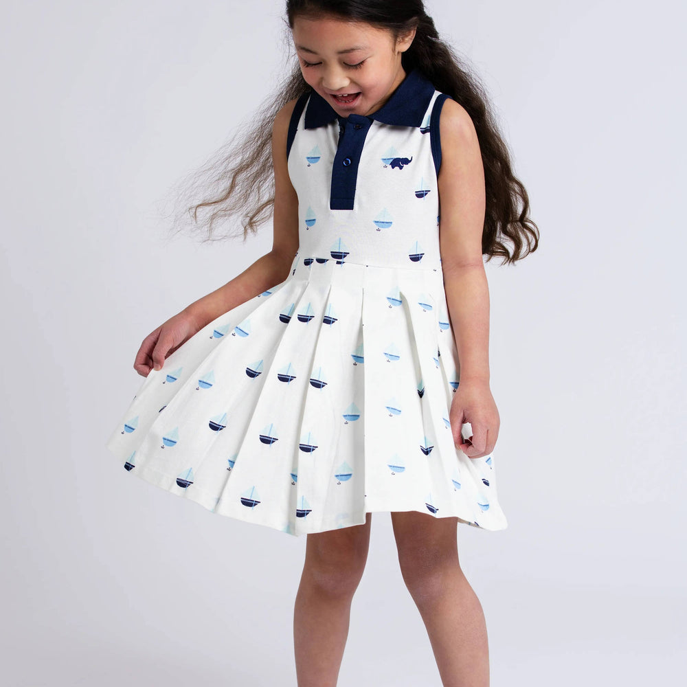
                      
                        Girl in Anchor Down tennis dress showing movement and twirl of pleated skirt, perfect for play
                      
                    