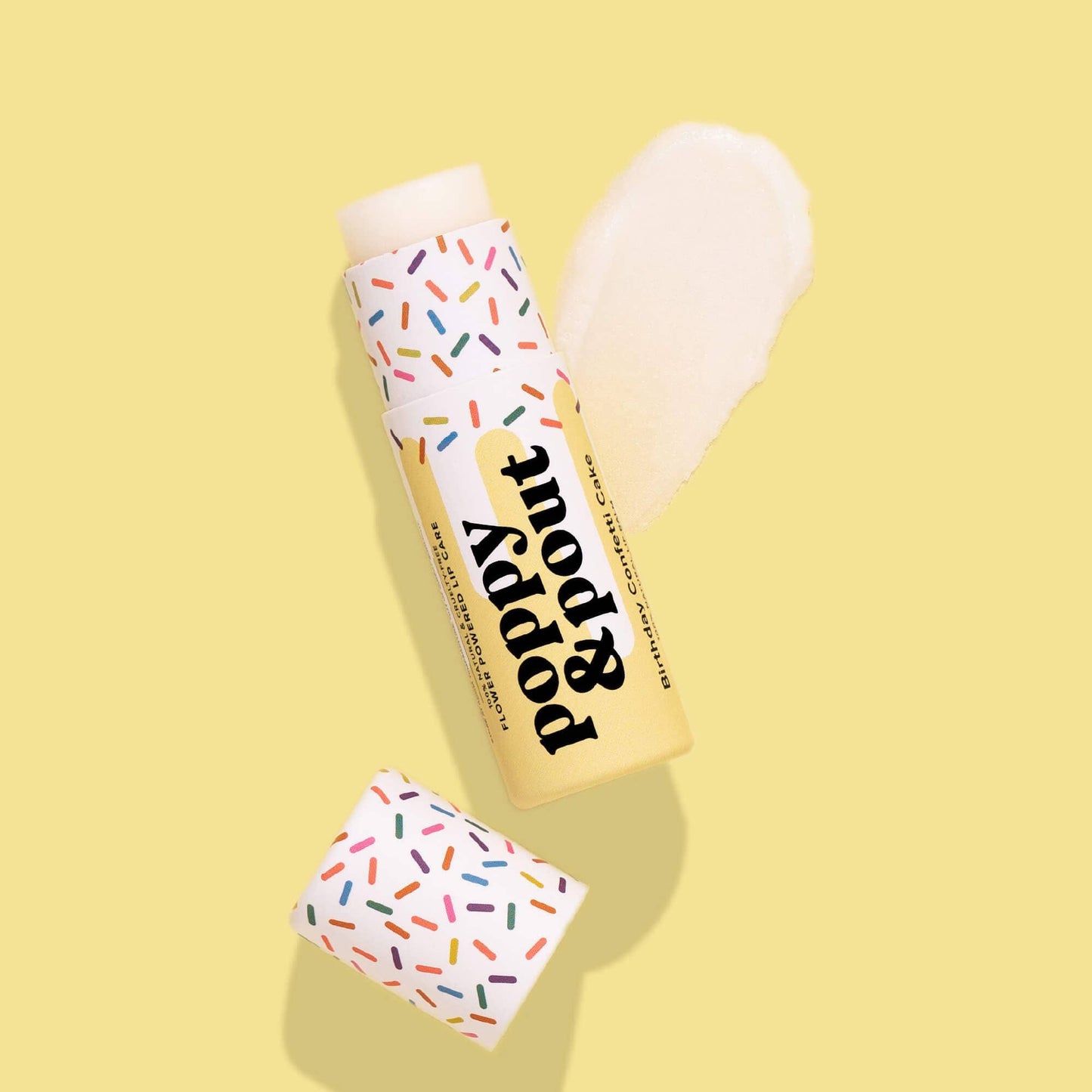 Poppy & Pout Birthday Confetti Cake natural lip balm in yellow tube.