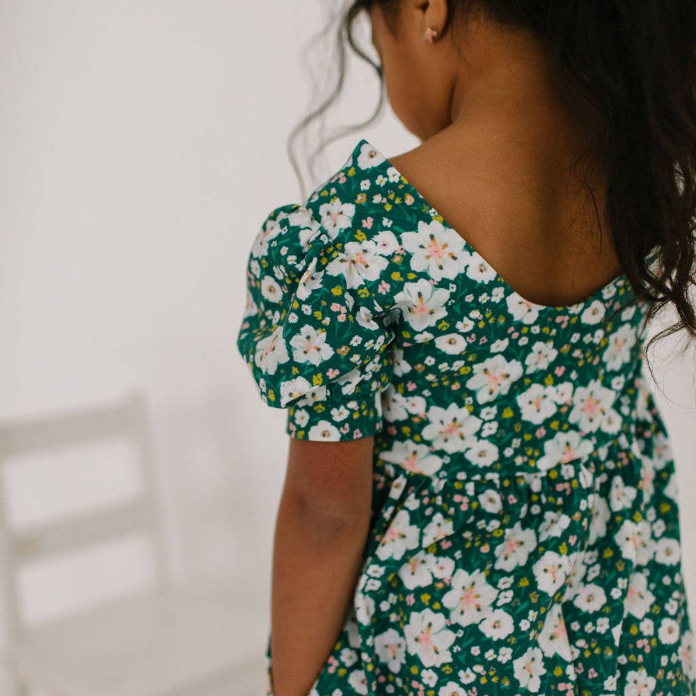 
                      
                        Toddler model showing the side pockets of the puff sleeve romper, perfect for playtime essentials.
                      
                    