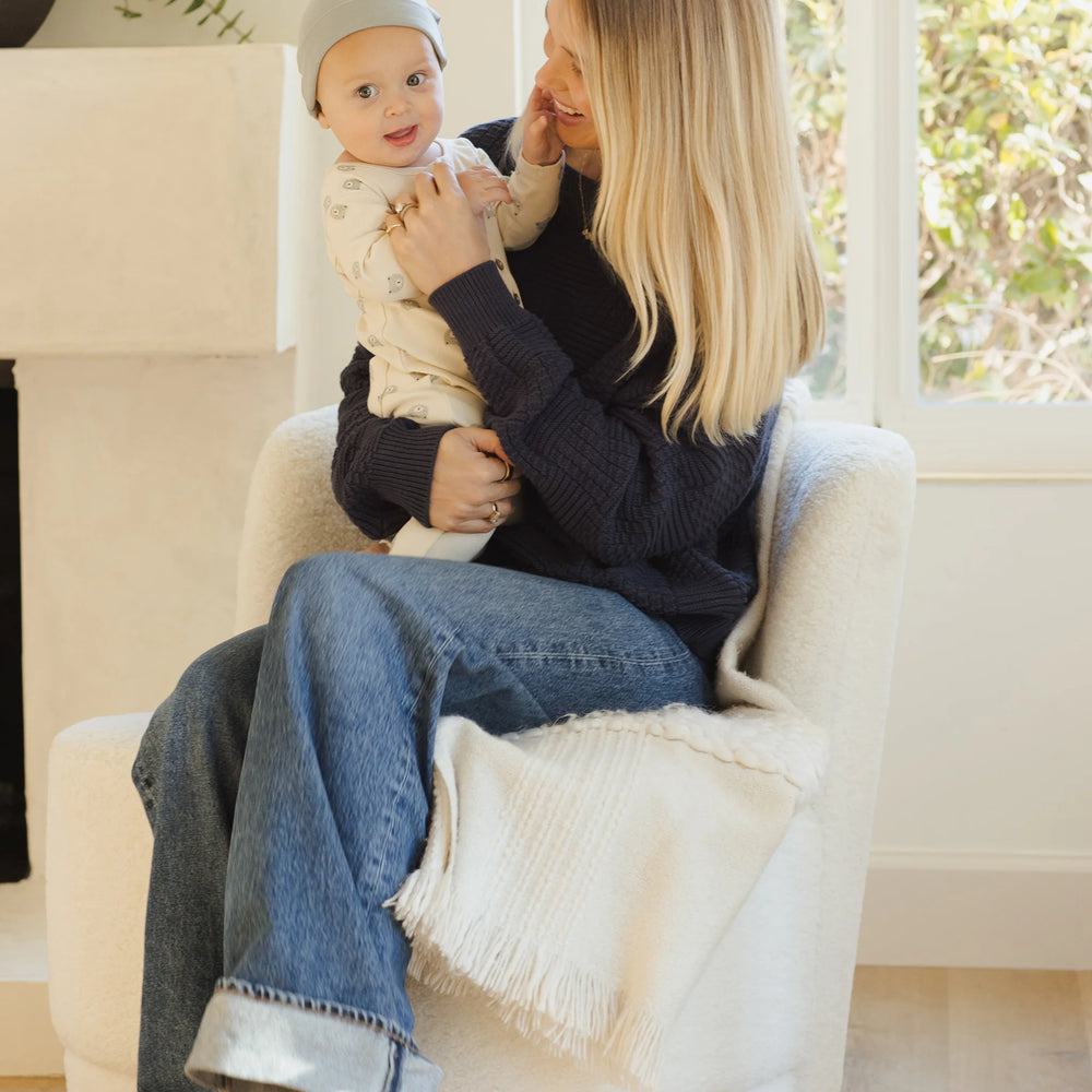 
                      
                        Baby in Quincy Mae bears jumpsuit with mom, both looking at camera, showcasing cozy one-piece for everyday wear.
                      
                    