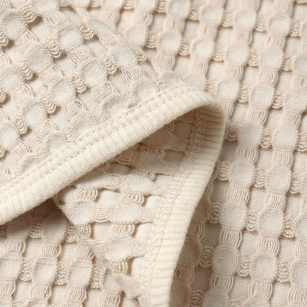 
                      
                        Detailed close-up of natural chunky waffle knit fabric from Quincy Mae Flynn Set, showing breathable texture and softness.
                      
                    