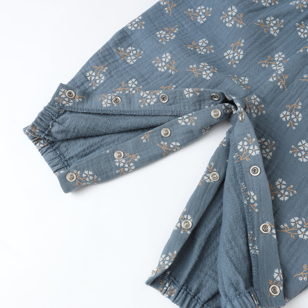 Close-up of blue floral print and adjustable strap detail on Quincy Mae Maisie Overall with coordinating bloomers.