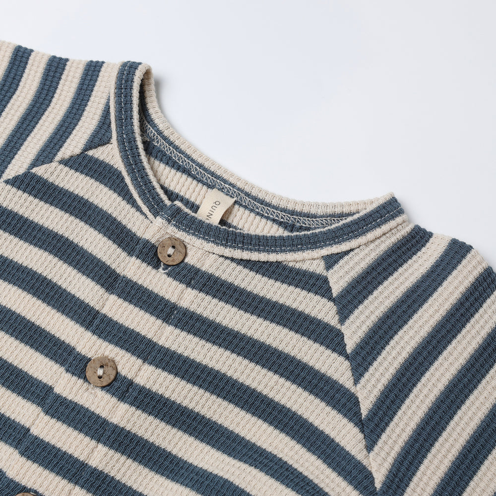 Close-up of ocean stripe pattern and waffle knit texture on Quincy Mae Waffle Long Sleeve Jumpsuit with hidden snaps.
